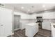 Bright kitchen featuring white cabinets, island, stainless steel appliances, and tile backsplash at 34949 N Spur Cir, San Tan Valley, AZ 85144