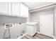 Laundry room with white cabinets, sink, and door to garage at 34949 N Spur Cir, San Tan Valley, AZ 85144
