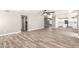 Bright open-plan living room with modern flooring, ceiling fan, and neutral paint at 34949 N Spur Cir, San Tan Valley, AZ 85144
