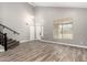 Bright living room featuring high ceilings, wood-look tile flooring, and a sun-filled window at 34949 N Spur Cir, San Tan Valley, AZ 85144