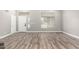 Bright living room featuring high ceilings, wood-look tile flooring, and a white front door at 34949 N Spur Cir, San Tan Valley, AZ 85144