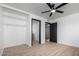 Bedroom with light-toned wood look floors, ceiling fan, and built in closet space at 3802 N 48Th Dr, Phoenix, AZ 85031