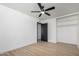 Bedroom with light-toned wood look floors, ceiling fan, and built in closet at 3802 N 48Th Dr, Phoenix, AZ 85031