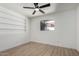 Bedroom with light-toned wood look floors, ceiling fan, and built in shelving at 3802 N 48Th Dr, Phoenix, AZ 85031
