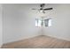 Bright bedroom features wood-look floors, ceiling fan and sunlit corner windows at 3802 N 48Th Dr, Phoenix, AZ 85031
