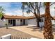 Exterior showing white brick home with brown roof and concrete driveway and desert landscaping at 3802 N 48Th Dr, Phoenix, AZ 85031