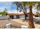 Exterior showing white brick home with brown roof and concrete driveway and desert landscaping at 3802 N 48Th Dr, Phoenix, AZ 85031