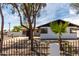 Charming home with white brick, black trim, desert landscaping, and a wrought iron fence at 3802 N 48Th Dr, Phoenix, AZ 85031