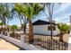 Charming home with white brick, black trim, desert landscaping, and a wrought iron fence at 3802 N 48Th Dr, Phoenix, AZ 85031