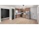 Modern kitchen featuring stainless appliances, wooden cabinets, and wood laminate flooring at 3802 N 48Th Dr, Phoenix, AZ 85031