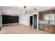 Bright, open-concept living space with sleek wood floors and adjacent kitchen area at 3802 N 48Th Dr, Phoenix, AZ 85031