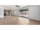 Bright open-concept living space features wood flooring, recessed lights, and slider doors to yard at 3802 N 48Th Dr, Phoenix, AZ 85031