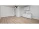 Large open living space with light-toned floors, door to the outside, and kitchen area at 3802 N 48Th Dr, Phoenix, AZ 85031