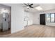 Open living area with kitchenette and bathroom, featuring light-toned wood-look floors at 3802 N 48Th Dr, Phoenix, AZ 85031