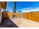 Backyard featuring a wooden fence, rock decor and palm trees at 4636 W Mission Ln, Glendale, AZ 85302