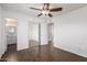 Bedroom with closet doors, wood-look tile flooring, neutral paint, and ceiling fan providing ample light at 4636 W Mission Ln, Glendale, AZ 85302