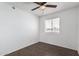 Bright bedroom features modern wood-look tile flooring and a ceiling fan with a window bringing in natural light at 4636 W Mission Ln, Glendale, AZ 85302