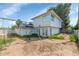 Spacious backyard showing the home's exterior and a vintage swing set at 4813 W Belmont Ave, Glendale, AZ 85301