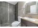Bathroom showcasing tiled shower, vanity with sink, toilet and mirror at 4813 W Belmont Ave, Glendale, AZ 85301