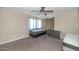 Bedroom featuring neutral walls and carpet, window with drapes, ceiling fan and dresser at 4813 W Belmont Ave, Glendale, AZ 85301