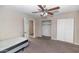 Bedroom with carpet and walls in neutral colors, open closet, doors and basic bed at 4813 W Belmont Ave, Glendale, AZ 85301