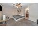 Comfortable bedroom featuring carpet flooring, a ceiling fan, and an ensuite bathroom for convenience and privacy at 4813 W Belmont Ave, Glendale, AZ 85301
