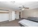 Bedroom with carpet and walls in neutral colors, ceiling fan, closet and door at 4813 W Belmont Ave, Glendale, AZ 85301