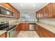 Functional kitchen featuring granite countertops, stainless steel appliances, and plenty of natural light from the window at 4813 W Belmont Ave, Glendale, AZ 85301