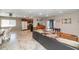 Open-concept living area with tile floors, seamlessly connecting the living, dining, and kitchen spaces at 4813 W Belmont Ave, Glendale, AZ 85301