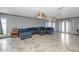Spacious living area with tile flooring, comfortable seating, and multiple ceiling fans for added comfort and air flow at 4813 W Belmont Ave, Glendale, AZ 85301