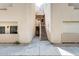 Exterior view with neutral-colored walls, stairs to upper units, and landscape details at 4850 E Desert Cove Ave # 240, Scottsdale, AZ 85254