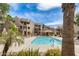 Exterior view of a pool, sun loungers, and tropical landscaping in the community at 4850 E Desert Cove Ave # 240, Scottsdale, AZ 85254