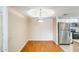 Open dining area with hardwood floors, a chandelier and stainless steel refrigerator nearby at 4850 E Desert Cove Ave # 240, Scottsdale, AZ 85254