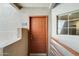 Exterior view of the front door, unit number 240, and a small window, enhancing curb appeal at 4850 E Desert Cove Ave # 240, Scottsdale, AZ 85254