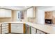 Bright kitchen featuring white countertops, cabinets, and a view of the fireplace at 4850 E Desert Cove Ave # 240, Scottsdale, AZ 85254