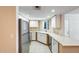 A well-lit kitchen with stainless steel appliances, white cabinets, and a window at 4850 E Desert Cove Ave # 240, Scottsdale, AZ 85254