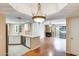 Open living area with hardwood floors, a fireplace, and a seamless flow to the kitchen at 4850 E Desert Cove Ave # 240, Scottsdale, AZ 85254