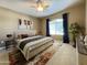 Relaxing bedroom with accent rug, contemporary décor, and large arched window for natural light at 5335 E Shea Blvd # 2045, Scottsdale, AZ 85254