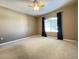 Spacious bedroom featuring neutral color palette, plush carpet, and a ceiling fan at 5335 E Shea Blvd # 2045, Scottsdale, AZ 85254