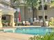 Community pool with barbecue, lounge chairs, and lush landscaping at 5335 E Shea Blvd # 2045, Scottsdale, AZ 85254