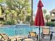 Community pool with lounge chairs, palm trees, and a fountain at 5335 E Shea Blvd # 2045, Scottsdale, AZ 85254