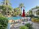 Community pool with lounge chairs, palm trees, and a fountain at 5335 E Shea Blvd # 2045, Scottsdale, AZ 85254