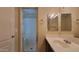 Bright bathroom featuring shower, vanity with sleek countertops and a contemporary mirror at 5628 S 21St Pl, Phoenix, AZ 85040