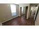 Bright bedroom featuring wood floors, closet with mirrored doors, and ample light at 5628 S 21St Pl, Phoenix, AZ 85040
