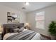 Staged bedroom with wood floors and view of tile roofs through window at 5628 S 21St Pl, Phoenix, AZ 85040