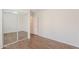Empty bedroom with wood floors and mirrored closet at 5628 S 21St Pl, Phoenix, AZ 85040
