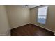 Comfortable bedroom featuring wood floors and bright natural light from the window at 5628 S 21St Pl, Phoenix, AZ 85040