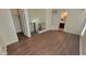 Upstairs hallway featuring wood floors, staircase views, and a bathroom with a glass block window at 5628 S 21St Pl, Phoenix, AZ 85040