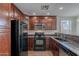 Updated kitchen featuring wood cabinets, granite counters, and modern appliances at 5628 S 21St Pl, Phoenix, AZ 85040