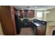 Updated kitchen with stainless steel appliances, granite countertops, and wood cabinetry at 5628 S 21St Pl, Phoenix, AZ 85040